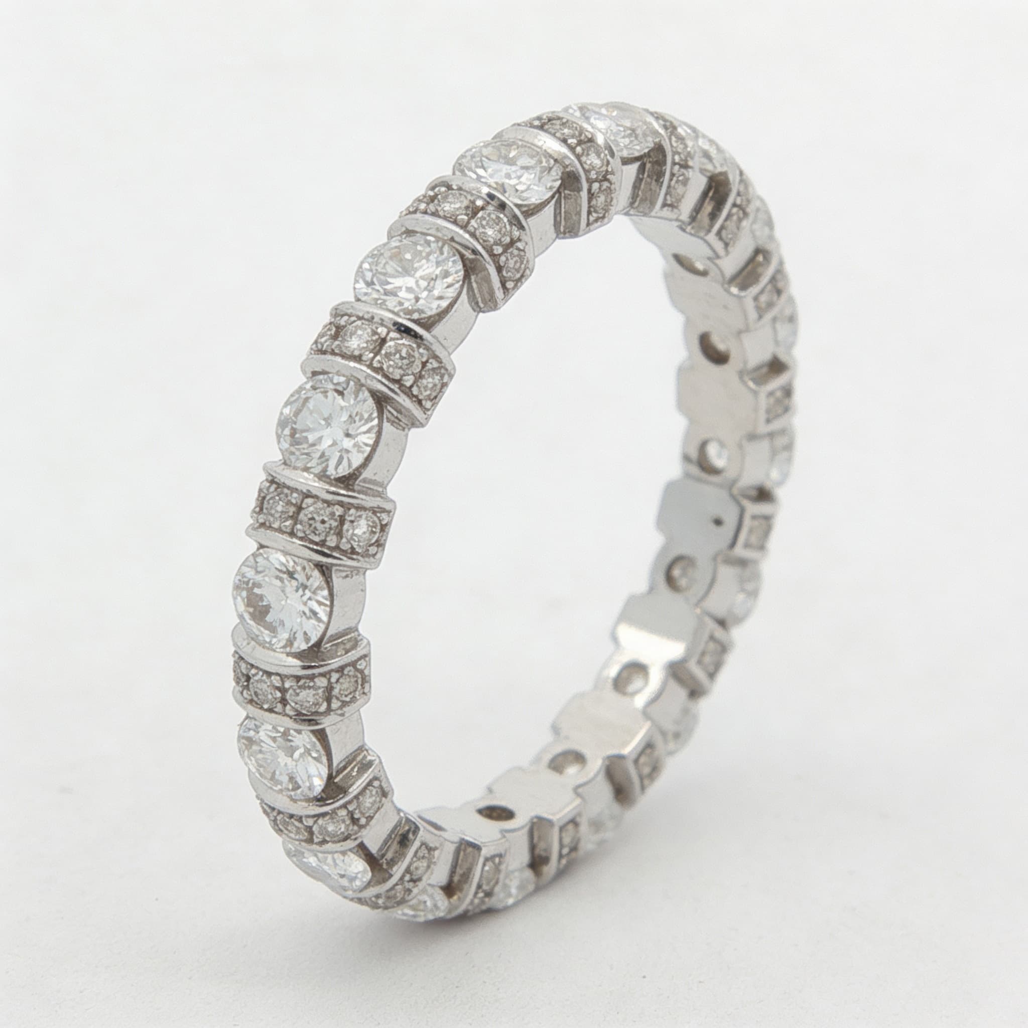 The Eternità Four-Prong Round Diamond Eternity Ring with Pavé Spacers - 3
