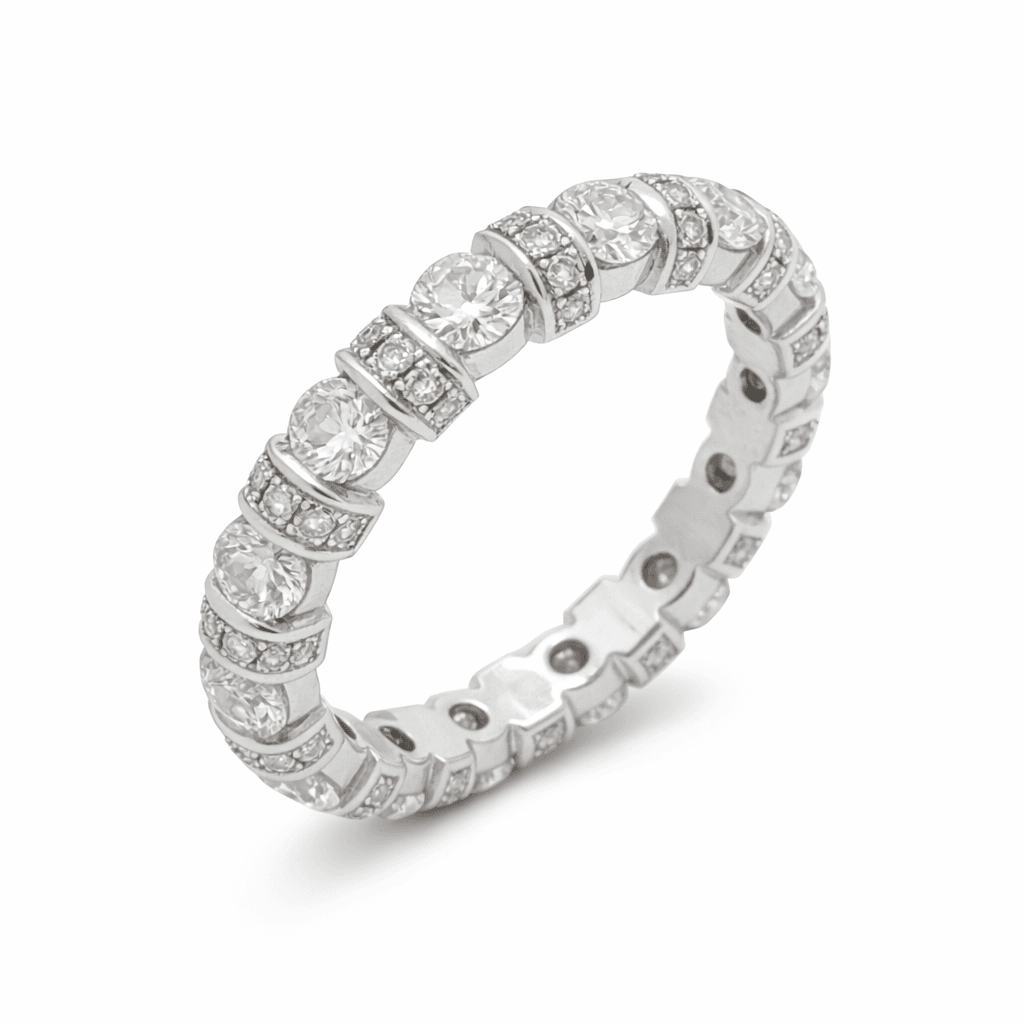 The Eternità Four-Prong Round Diamond Eternity Ring with Pavé Spacers